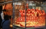 A customer (2nd L) visits a shop selling gold in Hong Kong on January 26, 2026. (Photo by Peter Parks / AFP)