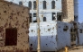 Children photographed near houses damaged with bullets in Omdurman. AFP file photo.