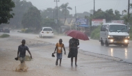 People walk in heavy rain in Harare, Zimbabwe, Jan. 24, 2026. (Str/Xinhua)