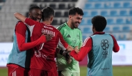 Al Arabi players celebrate their win over Qatar SC. 