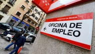 People walk outside a government employment office in the center of Madrid on January 3, 2014. Photo by GERARD JULIEN / AFP