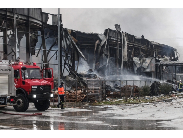 Firefighters try to extinguish a fire at a factory in Trikala on January 26, 2026. Photo by Thanasis KALLIARAS / Eurokinissi / AFP