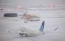 An Embraer 175 of United airlines taxies to take off as the snow falls on the tarmac of LaGuardia airport in New York on January 25, 2026. Photo by CHARLY TRIBALLEAU / AFP