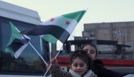 Children wave flags in Raqqa, northern Syria, January 21, 2026. (Str/Xinhua)