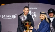 Chairman of the Board of Directors of Qatar Fund for Development H E Sheikh Thani bin Hamad Al Thani hands the trophy to Britain’s Scott Brash.
