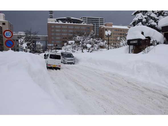 People commute along a snow-covered street in Aomori City, which is experiencing record-breaking heavy snowfall, on February 3, 2026. Photo by JIJI Press / AFP