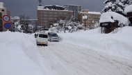 People commute along a snow-covered street in Aomori City, which is experiencing record-breaking heavy snowfall, on February 3, 2026. Photo by JIJI Press / AFP