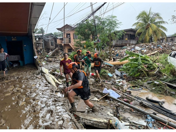 Rescuers evacuate a woman after Tropical Storm Penha hit the area in Iligan, Lanao del Norte province on February 6, 2026. (Photo by Merlyn Manos / AFP)