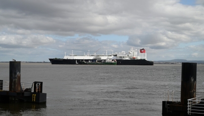 A small cargo ship next to an LNG tanker on the Tagus River off Lisbon, Portugal.