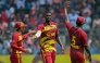 West Indies' Jason Holder (C) celebrates with teammates after taking the wicket of Nepal's Dipendra Singh Airee during the 2026 ICC Men's T20 Cricket World Cup group stage match between Nepal and West Indies at the Wankhede Stadium in Mumbai on February 15, 2026. (Photo by Indranil Mukherjee / AFP)