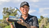 4Aces GC player Anthony Kim from the US celebrates with the trophy after winning the LIV Golf Adelaide tournament at The Grange Golf Club in Adelaide on February 15, 2026. (Photo by Brenton Edwards / AFP)
