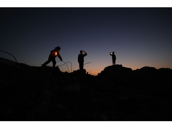 Young displaced Palestinians play on the ruins of destroyed buildings, carrying Ramadan lanterns, in central Gaza Strip on February 15, 2026. (Photo by Eyad Baba / AFP)
 