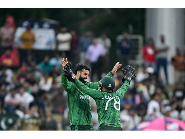 Pakistan's Shadab Khan (L) celebrates with wicketkeeper Usman Khan after taking the wicket of Namibia's Alexander Busing-Volschenk in Colombo on February 18, 2026. (Photo by Ishara S. Kodikara / AFP)