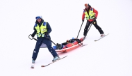 New Zealand's Finley Melville Ives is evacuated by a medical team in the freestyle skiing men's freeski halfpipe qualification run 2 during the Milano Cortina 2026 Winter Olympic Games at Livigno Snow Park, in Livigno (Valtellina), on February 20, 2026. (Photo by Kirill KUDRYAVTSEV / AFP)