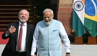 India's Prime Minister Narendra Modi (R) holds hands with Brazil's President Luiz Inacio Lula da Silva as they walk before their meeting at the Hyderabad House in New Delhi on February 21, 2026. (Photo by Sajjad Hussain / AFP)