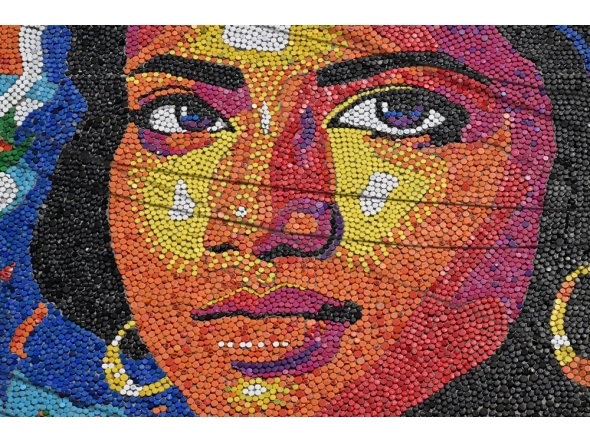 A mural made with plastic bottle caps by Venezuelan artist Oscar Olivares is seen on an apartment building in the Zacamil neighborhood in Mejicanos, El salvador, on February 20, 2026.  (Photo by Marvin Recinos / AFP)
