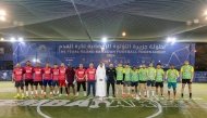 Executive Director of Public Services at UDC Eng. Abdullatif Al-Yafei with players at the event.