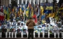 A person stands at a makeshift memorial to fallen Ukrainian and foreign soldiers in Independence Square in Kyiv on February 23, 2026. (Photo by HENRY NICHOLLS / AFP)