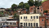 Rescue teams remove debris in search of victims of a landslide caused by heavy rains in the Barrio Parque Jardim Burnier neighbourhood in Juiz de Fora, Minas Gerais State, Brazil, on February 24, 2026. (Photo by Pablo PORCIUNCULA / AFP)