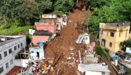 In this aerial view rescuers search for victims amid the rubble and mud of a house after a landslide triggered by heavy rains in the Paineiras neighborhood in Juiz de Fora, Minas Gerais State, Brazil, on February 25, 2026. Photo by Pablo PORCIUNCULA / AFP