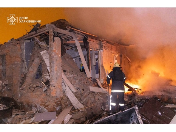 Handout photo by the State Emergency Service of Ukraine shows a firefighter extinguishing a fire in a damaged house following a Russian attack in Kharkiv. (Photo by Handout / State Emergency Service of Ukraine / AFP)