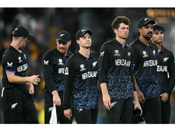 New Zealand's captain Mitchell Santner (3R) walks off the ground with his teammates following their win at the R Premadasa Stadium in Colombo on February 25, 2026. (Photo by Dibyangshu Sarkar / AFP)