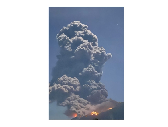 This handout photo taken on February 26, 2026 courtesy of the Facebook page of Ethan Asentista shows the eruption of Kanlaon volcano as seen from Canlaon City, Negros Oriental province in the central Philippines. (Photo by Handout / Courtesy of Ethan Asentista / AFP) 