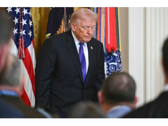 US President Donald Trump departs the stage after hosting a Medal of Honor ceremony in the East Room of the White House on March 2, 2026, in Washington, DC. (Photo by SAUL LOEB / AFP)