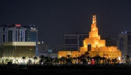 The illuminated Abdulla Bin Zaid al-Mahmud Islamic Cultural Center, also known as Fanar Mosque with the spiral-shaped minaret, is pictured at night in Doha on March 1, 2026. Photo by Karim Jaafar / AFP