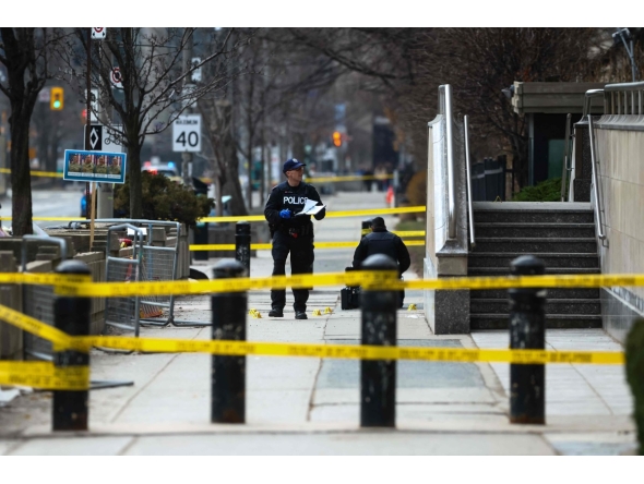 Toronto Police officers work around the scene of a shooting at the US Consulate in Toronto, Canada, on March 10, 2026. (Photo by Cole BURSTON / AFP)
