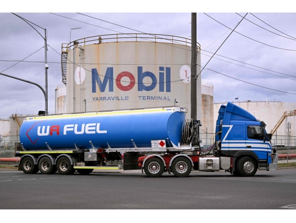 A fuel tanker passes the Mobil fuel distribution centre in the Melbourne suburb of Yarraville on March 12, 2026 as the demands and prices of petrol and diesel soar due to the Middle East conflict.  (Photo by William West / AFP)