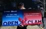 A man holds a placard featuring OpenClaw, an open-source AI assistant, during an event at the Baidu headquarters in Beijing on March 11, 2026. Photo by ADEK BERRY / AFP