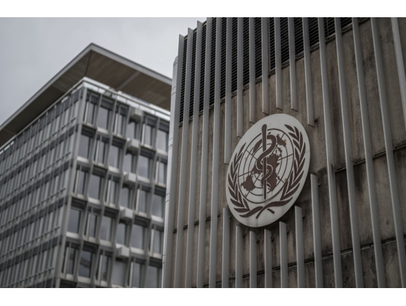 This photograph shows a logo of the World Health Organisation (WHO) displayed on the facade of organisation's headquarters in Geneva on April 23, 2025. Photo by Fabrice COFFRINI / AFP