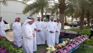 Minister of Municipality H E Abdullah bin Hamad bin Abdullah Al Attiyah with other officials during their visit to a local farm.
