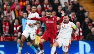 Liverpool's Egyptian forward #11 Mohamed Salah (C) fights for the ball during the UEFA Champions League, round of 16 second leg football match between Liverpool and Galatasaray on March 18, 2026. (Photo by Paul ELLIS / AFP)