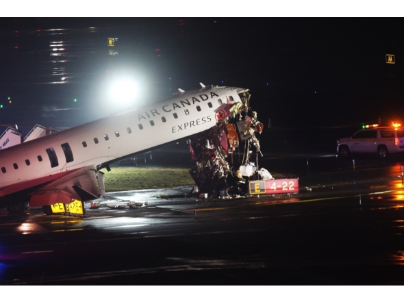 An Air Canada Express plane sits on the tarmac after it collided with a fire truck on the tarmac at LaGuardia Airport on March 23, 2026 in New York City. The plane had landed from a flight from Montreal. Spencer Platt/Getty Images/AFP 