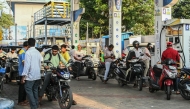 People queue to refuel at a petrol station in Hyderabad on March 25, 2026. Photo by NOAH SEELAM / AFP