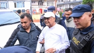 Nepal's former prime minister KP Sharma Oli (C) is escorted by police as he is brought to the hospital following his arrest in Kathmandu on March 28, 2026. (Photo by Prakash Mathema / AFP)