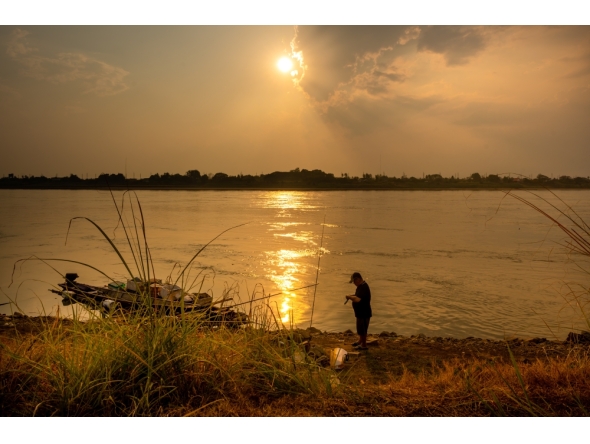 A man fishes along the Mekong River in Vientiane, Laos, March 22, 2026. (Photo by Kaikeo Saiyasane/Xinhua)