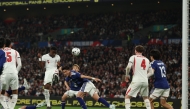 England's defender Marc Guehi (L) heads towards goal during the friendly international football match between England and Japan at Wembley Stadium in London on March 31, 2026. (Photo by Adrian Dennis / AFP) 
