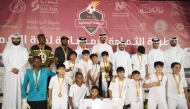 Al Wajba players celebrate with the trophy. Chairman of the Organising Committee Hassan Ali Al Ishaq and Tournament Director Youssef Ali Abdul Noor are also present.   