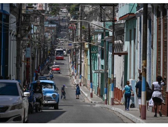 People walk down a street in Matanzas, Cuba, on March 31, 2026. (Photo by Yamil Lage / AFP)
