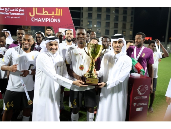 QSL CEO Hani Taleb Ballan presents the winner's trophy to Al Riffa captain.