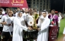 QSL CEO Hani Taleb Ballan presents the winner's trophy to Al Riffa captain.