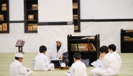 Children learn Quran recitation at a mosque.  