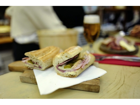 This photograph shows a butter, ham, cheese and pickles baguette sandwich at the counter of Le Petit Vendome cafe bistrot in Paris on September 16, 2025. Photo by Ludovic MARIN / AFP