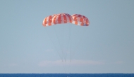 This handout photo released by NASA shows NASA's Orion spacecraft as it lands in the Pacific Ocean off the coast of California, on April 10, 2026. (Photo by Bill INGALLS / NASA / AFP) 