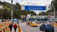 (Files) Vehicles and people cross the Rumichaca International Bridge on the Colombia-Ecuador border, in Ipiales, Narino department, Colombia, on January 21, 2026. (Photo by Reicarmyr Canizares / AFP)