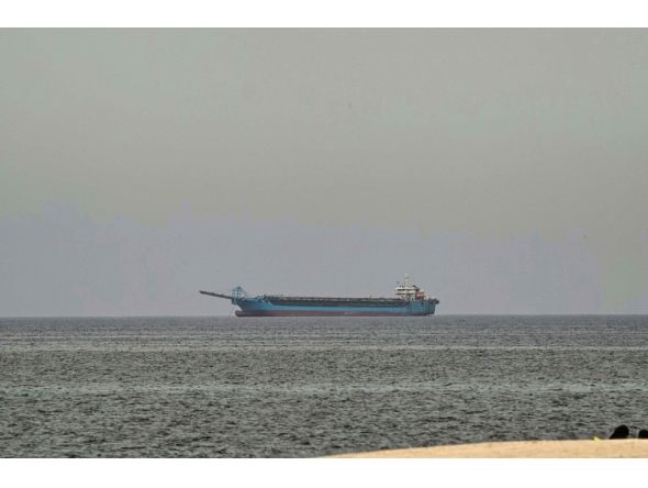 A ship is seen off the coast of Sharjah, the day after the failure of US-Iran peace talks on April 13, 2026. (Photo by AFP)