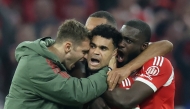 Bayern Munich's Colombian forward #14 Luis Diaz (C) celebrates scoring the 3-3 goal with his teammates during the UEFA Champions League quarter-final second leg football match between FC Bayern Munich and Real Madrid in Munich, southern Germany, on April 15, 2026. (Photo by Alexandra BEIER / AFP)